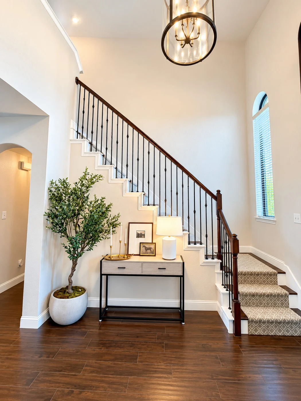 Bright home entryway with a staircase and console table