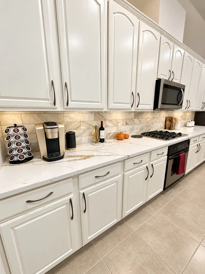 Clean white kitchen cabinets, counters, and appliances