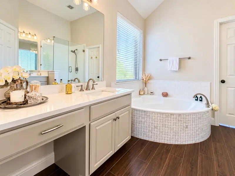 Freshly cleaned bathroom vanity, tub, and floor